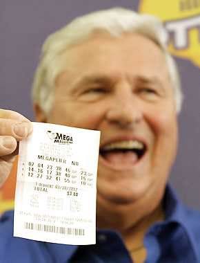 Merle Butler of Red Bud, Illinois, holds up his winning lottery ticket during a news conference at the Red Bud Village Hall. This Mega Millions jackpot had three winning tickets on March 30, 2012. One ticket was purchased by a retired couple in their 60s, Merle and Patricia Butler. Seth Perlman | Associated Press