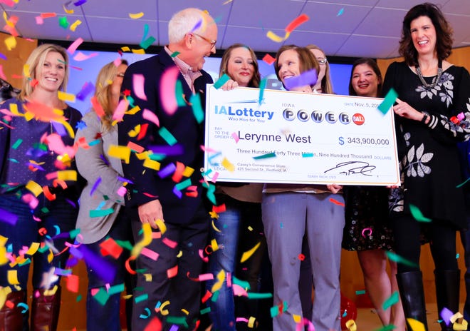 Lerynne West steps forward to claim a $343.9 million Powerball jackpot, the largest prize in Iowa history Monday, Nov. 5, 2018.
