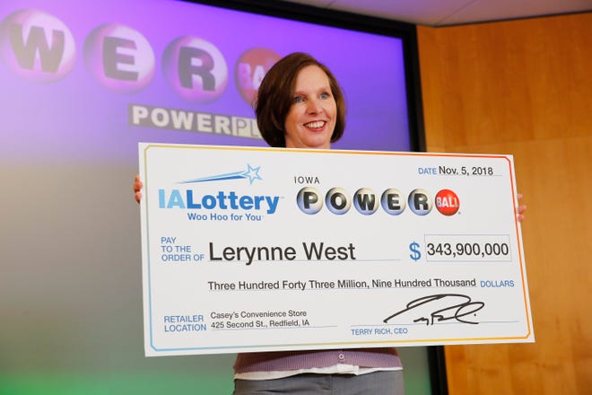 Lerynne West steps forward to claim a $343.9 million Powerball jackpot, the largest prize in Iowa history Monday, Nov. 5, 2018.
