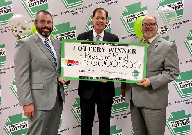 From left: Christopher Mahoney, attorney with Stuckert & Yates, Kurt Panouses, attorney with Panouses Law Firm, and Pennsylvania Lottery Executive Director Drew Svitko receive ceremonial check on behalf of PEace of Mind Trust, the winner of the jackpot.